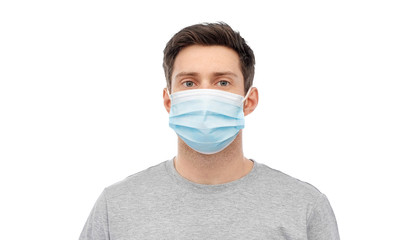 health, quarantine and pandemic concept - portrait of young man wearing medical mask for protection from virus disease on white background