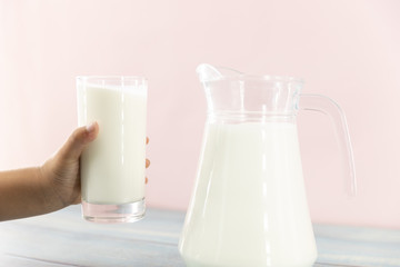 Child hand with a glass of milk. Drink milk for good health concept.