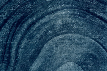 Wooden detailed texture of cut tree trunk cross-section or stump. Trendy blue color 2020. Macro,...