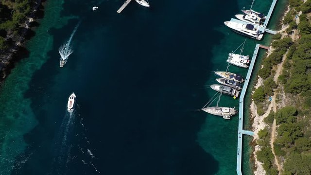 Yacht navigating into Marina Palmizana on Paklinski Islands near City of Hvar - Aerial View