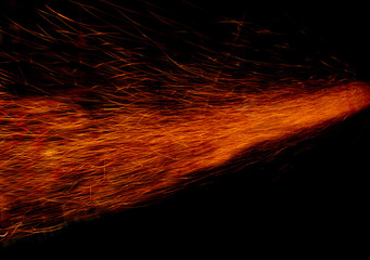 long sparks of fire on a black background