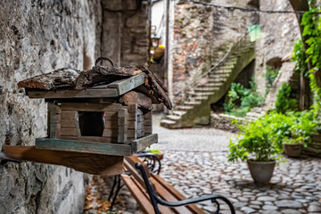 Wooden bird house on the streets of old Tallinn, Estonia. Stylized bird feeder.