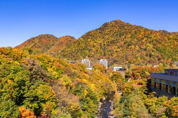 札幌市・定山渓温泉にて見返り坂近辺から色とりどりの紅葉に染まる山を眺める