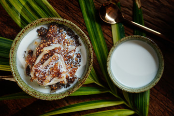 Tapioca pearls form sago tree. Still life photography of Thai dessert Sago palms with coconuts or sago pearls in coconut milk on the table. Popular dessert in Thailand served with fresh coconut milk.