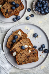 Slices of banana bread with berries on gray plate, top view. Healthy vegan food concept.
