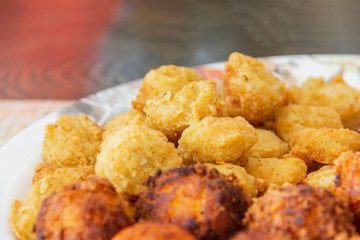 delicious chicken nugget fried with cheese ball on white disc ready eat