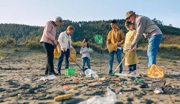 Group Of Volunteers Preparing To Clean The Beach