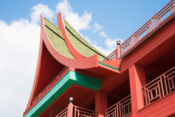 Architectural elements of a Southeast Asian building. Roof close-up. Against a background of blue...
