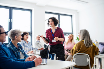 Group of senior people attending computer and technology education class.