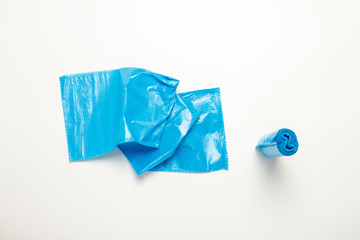 Blue trash bag on an isolated white background. The concept of cleaning, garbage removal. Flat lay, top view