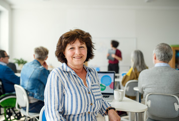 Portrait of senior attending computer and technology education class.