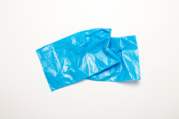 Blue trash bag on an isolated white background. The concept of cleaning, garbage removal. Flat lay, top view