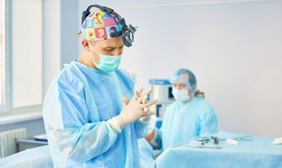 Several doctors surrounding patient on operation table during their work. Team surgeons at work in operating room