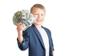 Cute caucasian boy is holding a fan of a pack of hundred-dollar bills, smiling and looking at the camera isolated on a white background with copy space. Successful businessman. - Powered by Adobe