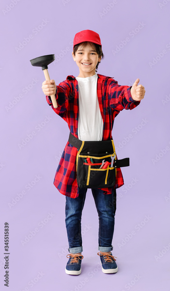 Poster portrait of little plumber showing thumb-up gesture on color background