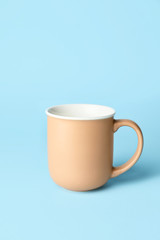 Blank cup on color background