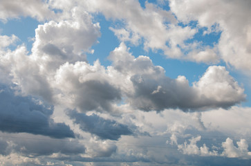 Fototapeta na wymiar large rain white clouds in the blue sky
