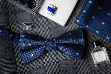 luxury bow tie close up with vintage suit, cufflink, perfume bottle