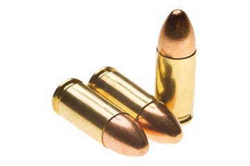 Shiny 9 mm caliber Bullets. Close-up of a 9mm full metal jacket ammo isolated on white background with reflection