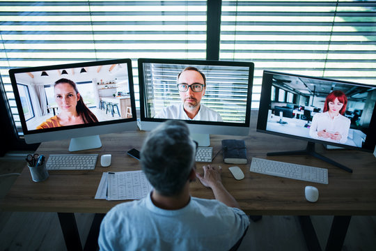 Businessman with computer sitting at desk, working. Business call concept.