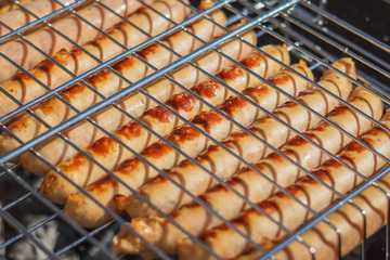 Grilling sausages on barbecue grill. Selective focus - 345519401