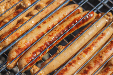 Grilling sausages on barbecue grill. Selective focus - 345519453
