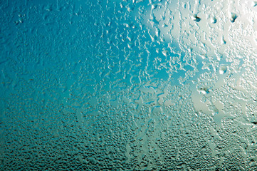 Raindrops or steam shower, on a transparent glass background. Realistic clean drops flow down.