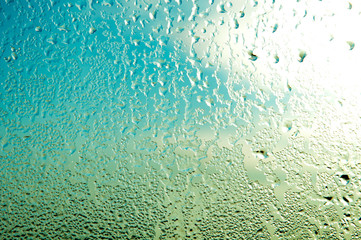 Raindrops or steam shower, on a transparent glass background. Realistic clean drops flow down.