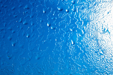 Raindrops or steam shower, on a transparent glass background. Realistic clean drops flow down.