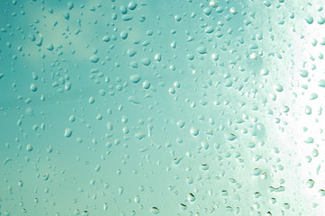Raindrops or steam shower, on a transparent glass background. Realistic clean drops flow down.