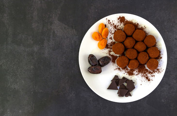 No bake healthy energy balls with cocoa. Made of figs, dates, apricots, and cranberries. Top view, copy space