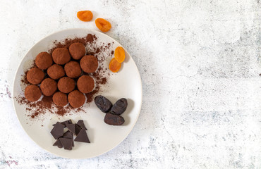 No bake healthy energy bites with cocoa. Made of figs, dates, apricots, and cranberries. Top view, copy space