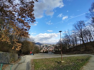 Obraz premium Sunrise and sunset, beautiful clouds over the meadow, hills and buildings in the town. Slovakia