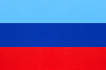 Luhansk People's Republic national fabric flag from textile. Symbol of unrecognised state of Ukraine.