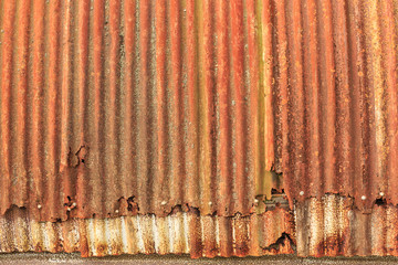Rusty, overlapping sheets of corrugated iron from an old Quonset hut