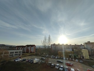 Sunrise and sunset, beautiful clouds over the meadow, hills and buildings in the town. Slovakia