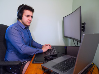 Young caucasian programer man in underwear with headphones thinking about a work problem