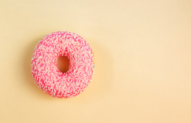 donuts with pink glaze on a yellow background