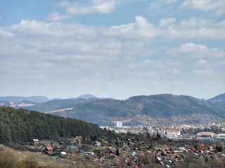 Sunrise and sunset, beautiful clouds over the meadow, hills and buildings in the town. Slovakia