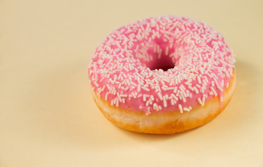 donuts with pink icing, on a yellow background a sweet dessert for breakfast