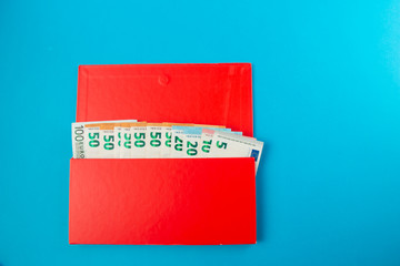 red box with savings euro banknotes on a blue background