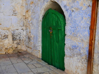 old green wooden door and white stone wall in a corner, scenery on top of Church of the Holy Sepulchre, Jerusalem, Israel, Near East