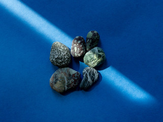 Pebbles in a sunbeam on a blue background.