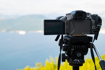 Photo camera on a tripod captures the Bay of Kotor Montenegro.