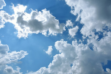 White clouds on the blue sky. Sunny day.