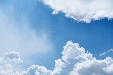White clouds on the blue sky. Sunny day.