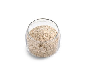 White sesame seeds in glass bowl on white background