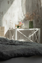 Photo of a wooden dog on wheels of beech in bright bedroom.