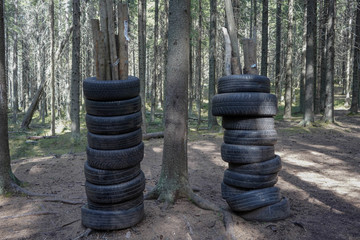 homemade bag for practicing blows. Car tires clad on tree trunks.