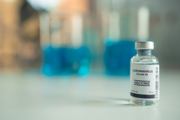Close-up on Laboratory Tube Virus corona covid 19 vaccine. Scientist research for new novel corona virus immunization drug concept. Coronavirus COVID-19 vaccine vial and injection syringe.